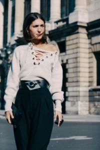 A stylist woman dressed in white sweater and black shirt in Paris